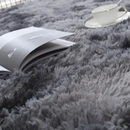 Gray shag rug with book and teacup showcasing trendy Vikama Tie-Dye Silk Wool rug