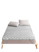 Gray quilted mattress protector.