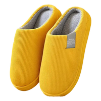 Yellow corduroy slippers with gray lining.