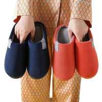 Corduroy slippers in blue and orange.