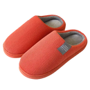 Pair of orange corduroy slippers.