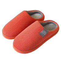 Pair of orange corduroy slippers.