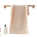 Peach-colored towel on a wooden rack.