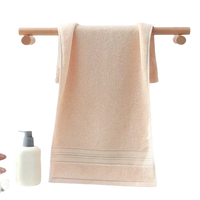 Peach-colored towel on a wooden rack.