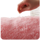 Soft pink shag rug.