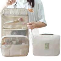 Beige hanging travel toiletry bag.