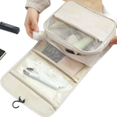 Beige hanging travel toiletry bag.