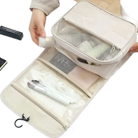 Beige hanging travel toiletry bag.