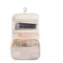 Hanging cosmetic organizer with multiple compartments.