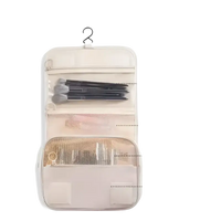 Hanging cosmetic organizer with multiple compartments.