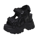 Black platform sandal with velcro straps.