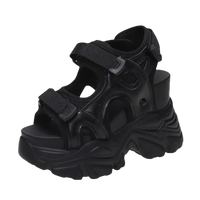 Black platform sandal with velcro straps.