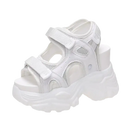 White platform sandal with velcro straps.
