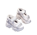 White platform sandals with velcro straps.