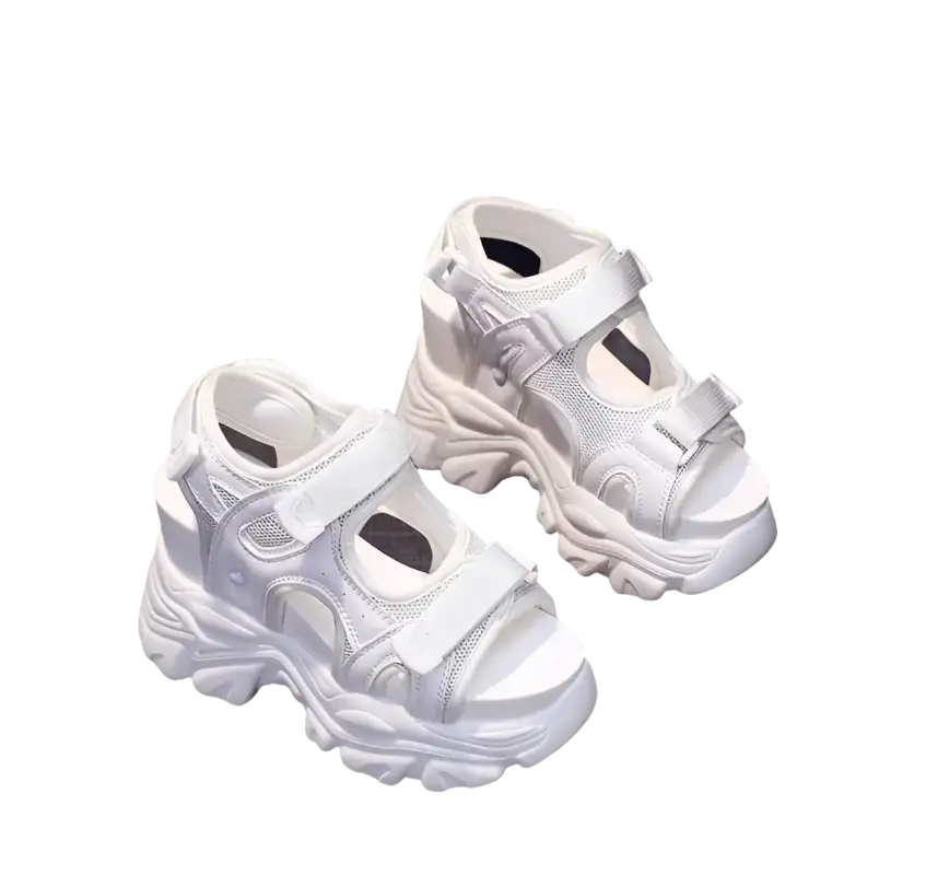 White platform sandals with velcro straps.