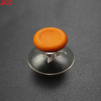 Orange joystick with clear suction cup base.