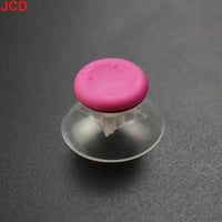 Pink joystick cap with clear suction cup.