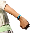 Blue fitness tracker on wrist.