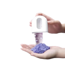 White dispenser sprinkling purple powder.