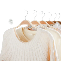 Clothes hanging in a wardrobe.