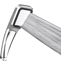 Chrome shower head with water flowing.