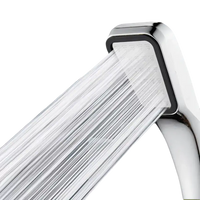 Chrome shower head with water flowing.