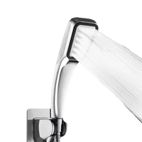 Chrome shower head with water stream.