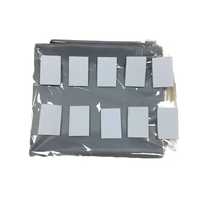 Gray organizer with white squares in plastic wrap.