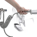 Handheld bidet sprayer with coiled hose.