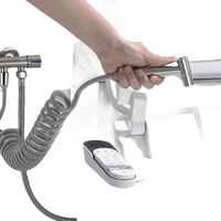 Handheld bidet sprayer with coiled hose.